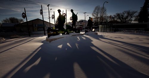 A trio of silouettes march across a snowy landscape at Valour Road and Seargant ave Thursday. The three figures represent a trio of Victoria Cross WInners who lived on the former Pine Street. See story. Jan 2, 2014 - (Phil Hossack / Winnipeg Free Press) Remembrance Day