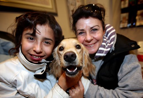 Carolina Villa (11) poses with her newly found (and immigrated) dog Talia Thursday night with Lois Reid who stopped in traffic to scoop up the lost and disoriented pup.  See story. Jan 2, 2014 - (Phil Hossack / Winnipeg Free Press)
