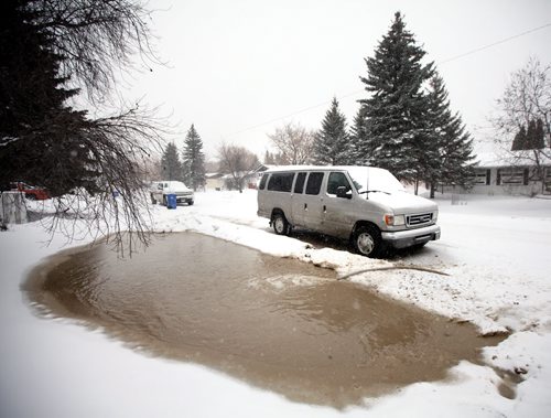 Ditches and excavations flooded with water along Laxdal rd in Charleswood Friday afternoon. See Kevin Rollason story. January 3, 2014 - Phil Hossack / Winnipeg Free Press)
