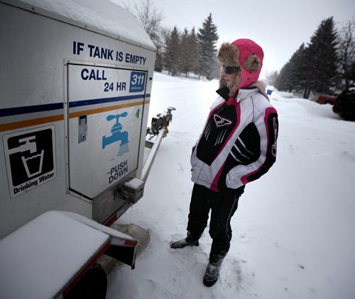 Laxdal rd resident Jody Kardash checks out a trailer holding temporary water supplies for her block Friday afternoon. See Kevin Rollason story. January 3, 2014 - Phil Hossack / Winnipeg Free Press)