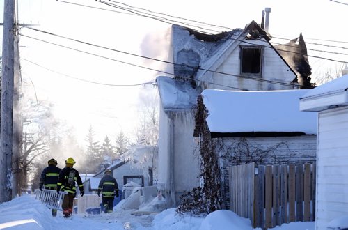Firefighters battle a blaze at a two storey structure off of Chalmers in Elmwood, Saturday, January 4, 2014. (TREVOR HAGAN/WINNIPEG FREE PRESS)