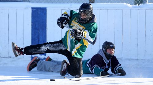 Kyle Macpherson of the Tumbleweeds, plays the puck from his knee after getting tangled up with one of the Mighty Puckin Drunks during a spongee game at Melrose Community Centre, Saturday, Wednesday, January 4, 2014. The Tumbleweeds are the oldest spongee team in the world. (TREVOR HAGAN/WINNIPEG FREE PRESS) - for dave sanderson