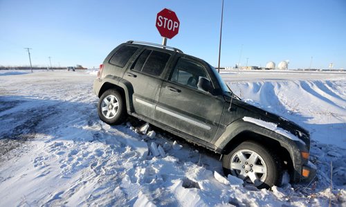 A vehicle in the ditch near Provincial Road 330 and the Perimeter Highway, Saturday, Wednesday, January 4, 2014. (TREVOR HAGAN/WINNIPEG FREE PRESS)