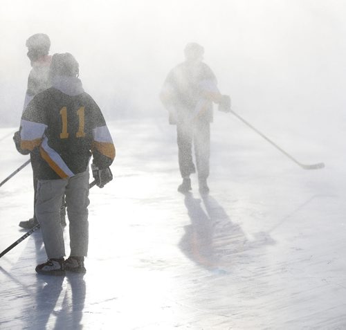 Members of the Tumbleweeds and the Mighty Puckin Drunks are completely covered in snow from a passing snow blower that was cleaning a neighbouring ice surface during a spongee game at Melrose Community Centre, Saturday, Wednesday, January 4, 2014. The Tumbleweeds are the oldest spongee team in the world. (TREVOR HAGAN/WINNIPEG FREE PRESS) - for dave sanderson