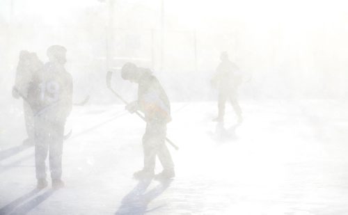 Members of the Tumbleweeds and the Mighty Puckin Drunks are completely covered in snow from a passing snow blower that was cleaning a neighbouring ice surface during a spongee game at Melrose Community Centre, Saturday, Wednesday, January 4, 2014. The Tumbleweeds are the oldest spongee team in the world. (TREVOR HAGAN/WINNIPEG FREE PRESS) - for dave sanderson