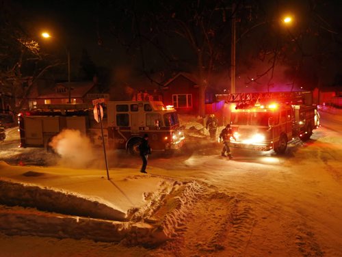 several people evacuated the house - House and attached garage fire heavily damaged a house on the 1300 block of Edderton Ave at the corner of Beaumont ST. ,fire crews are just finishing up with the  early morning fire . JAN. 6 2014 / KEN GIGLIOTTI / WINNIPEG FREE PRESS