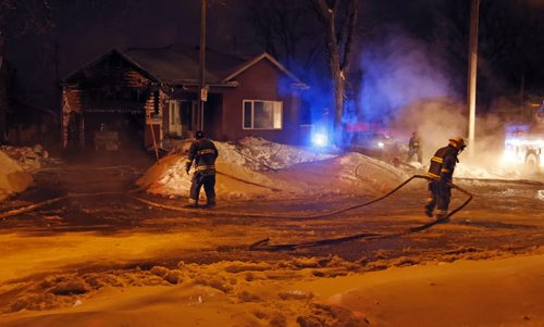 Overnight Fires  - WFS  mop up after frigid House and attached garage fire heavily damaged a house on the 1300 block of Edderton Ave at the corner of Beaumont ST. ,fire crews are just finishing up with the  early morning fire . JAN. 6 2014 / KEN GIGLIOTTI / WINNIPEG FREE PRESS