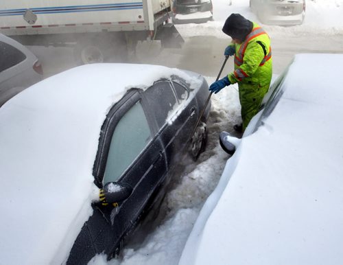 High pressure steam is used Monday morning to free vehicles parked in Northwood Oaks complex on Jefferson Ave. near Adsum Drive from ice after the major water main break last Tuesday. Thirty-two vehicles are then being towed from the lot they have been frozen in for all most a week.  Wayne Glowacki / Winnipeg Free Press Jan.6  2014