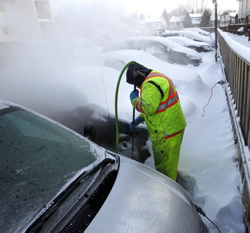 High pressure steam is used Monday morning to free vehicles parked in Northwood Oaks complex on Jefferson Ave. near Adsum Drive from ice after the major water main break last Tuesday. Thirty-two vehicles are then being towed from the lot they have been frozen in for all most a week.  Wayne Glowacki / Winnipeg Free Press Jan.6  2014
