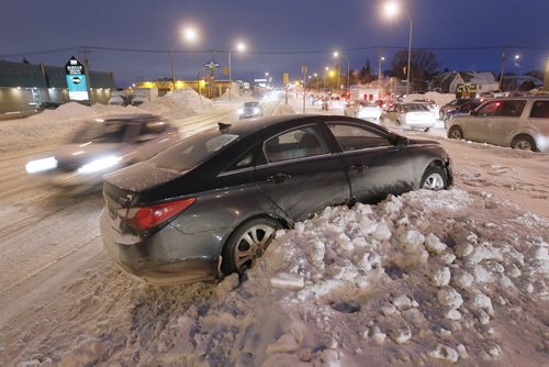 January 6, 2014 - 140106  -  A car ended up on Century Street boulevard after sliding on the icy rut filled road Monday, January 6, 2014. John Woods / Winnipeg Free Press