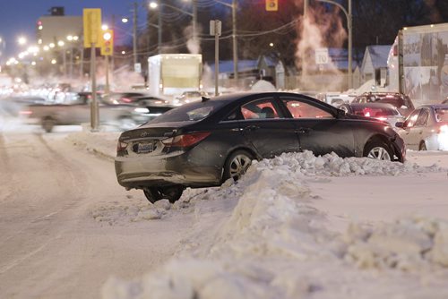 January 6, 2014 - 140106  -  A car ended up on Century Street boulevard after sliding on the icy rut filled road Monday, January 6, 2014. John Woods / Winnipeg Free Press