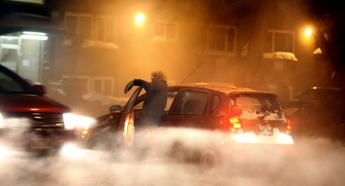 A woman gestures helplessly from her fog shrouded car Monday evening at Osborne Street and Melborne. A water main break complicated the evening commute flooding Osborne street south with icy sluch sticking her car in place..... January 6, 2014 - (Phil Hossack / Winnipeg Free Press)