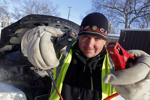 Steve Genaille, 44, is a dad of 5, works for his wife's courier company, caretaker of the three-storey 7 unit apartment building and is going around the city giving battery boosts to people who need help. He charges $20, but only $10 if he can't get it going. BORIS MINKEVICH / WINNIPEG FREE PRESS January 7, 2014