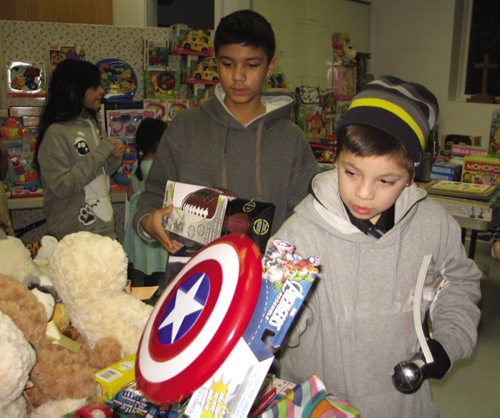 Canstar Community News Dec. 13, 2013 - Lewin Francois (right) and Myles Kakewash check out the toys. (JARED STORY/THE TIMES/CANSTAR COMMUNITY NEWS)