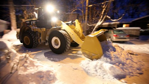 A snowplow works the WIldwood neighborhood's back lane access roads Wednesday. See story. January 8, 2014 - (Phil Hossack / Winnipeg Free Press)