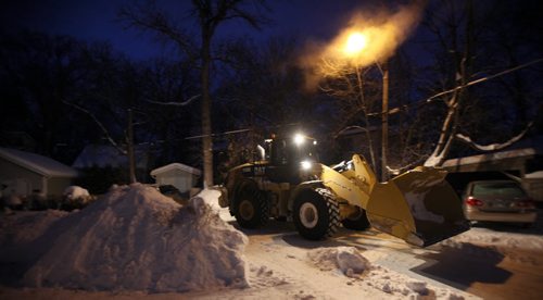 A snowplow works the WIldwood neighborhood's back lane access roads Wednesday. See story. January 8, 2014 - (Phil Hossack / Winnipeg Free Press)
