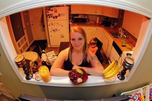 Kelly Zelinsky, wife and mother-of-three, lost 115 pounds in less than one year.  A shot of her in her kitchen surrounded by healthy food. REPORTER: Shamona Harnett. BORIS MINKEVICH / WINNIPEG FREE PRESS January 8, 2014