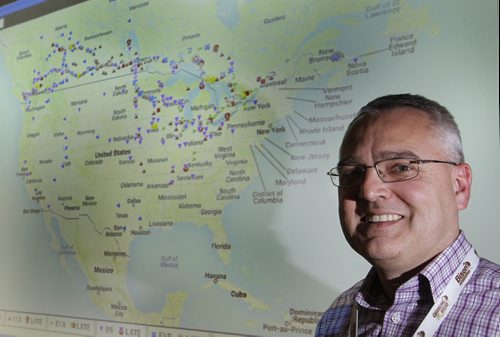 Garth Pitzel, Director, Safety and Driver Development by the projection showing in real time the locations of the entire Bison Transport fleet  , for feature on the hi-tech Bison Transport corporate office in Winnipeg.  Randy Turner story    Wayne Glowacki / Winnipeg Free Press Jan.8  2014