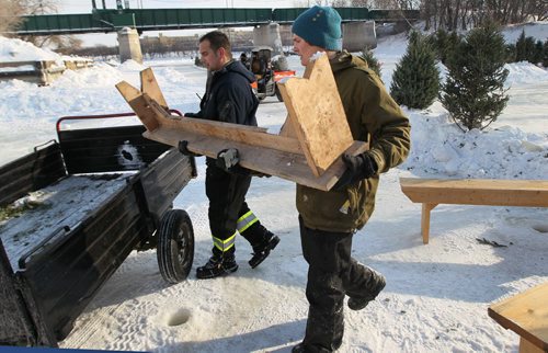 Braden Denedeiros, left, and  Adam Borton unload benches on  Assiniboine River preparing the Arctic Glacier Winter Park for the 2014 season- The skating trail will officially open Friday  See Kevin Rollason story- Jan 09, 2014   (JOE BRYKSA / WINNIPEG FREE PRESS)