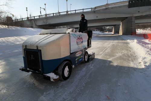 Patrick Jordon cruises down the Assiniboine River in a ice making machine preparing the Arctic Glacier Winter Park for the 2014 season- The skating trail will officially open Friday  See Kevin Rollason story- Jan 09, 2014   (JOE BRYKSA / WINNIPEG FREE PRESS)