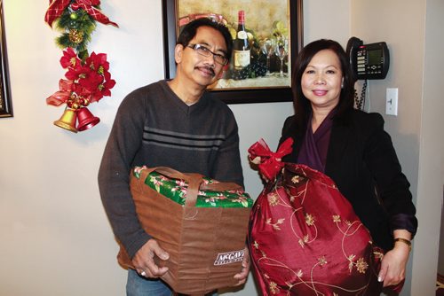 Canstar Community News Myra Rosario and her husband Mario with a couple of the holiday hampers that will be shipped off to the Philippines. (JORDAN THOMPSON)