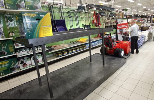 At left is the snow blower display that normally shows 12 different models, on Thursday Seasonal dept. manager Chris deBerk  is by the only one left on display at the Canadian Tire Store on Regent Ave.    For intern story on hot selling items during cold snap and snow fall.    Wayne Glowacki / Winnipeg Free Press Jan.9  2014