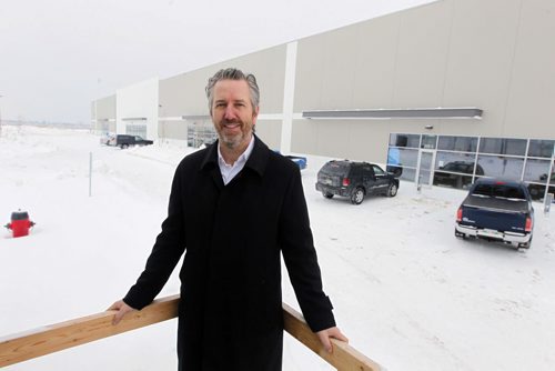 Shot of Gary Goodman, an industrial real estate specialist with the Winnipeg office of Colliers International,  in front of the 150,000 square foot distribution centre that was completed last fall.  Goodmans client , Transforce,  has leased 40,000 square feet in the building and has already begun moving in. For Monday column on how construction of new industrial buildings is picking up this year in Winnipeg. BORIS MINKEVICH / WINNIPEG FREE PRESS January 10, 2014