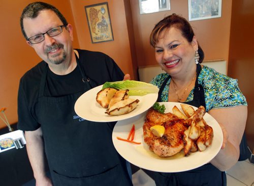 Restaurant Review - Simon's. Empanada (meat with raisin and olives) and Pollo Deshuesado. 513 St Mary's Road. José Sturym and Milagro Rodriguez in the photo. BORIS MINKEVICH / WINNIPEG FREE PRESS January 10, 2014