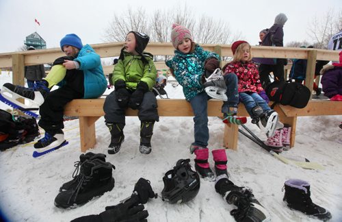 Kids get ready to go skating  on the newly opened  Red River Mutual Trail on the Assiniboine River at the Forks Saturday afternoon.  Names from left -  Sadie Rohne (blue) her brother Asher Rohne (6yrs), Teresa Yost (7yrs) and her sister Frances Yost (4yrs).   Jan 11,, 2014 Ruth Bonneville / Winnipeg Free Press
