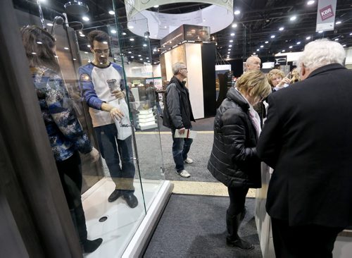 People check out a large two person shower at the Greenslade Bath display at the Kitchen, Bath and Renovation Show at the Winnipeg Convention Centre, Saturday, January 11, 2014. (TREVOR HAGAN/WINNIPEG FREE PRESS)