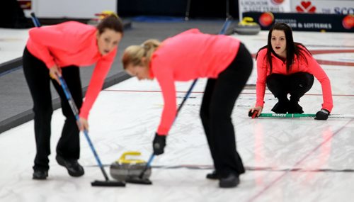 Liz Fyfe and Kristin MaCcuish sweep for skip, Kerri Einarson after she throws a rock against Chelsea Carey during the final of the Scotties Provincial Curling Championship at the Tundra Oil & Gas Place in Virden, Manitoba, Sunday, January 12, 2014. (TREVOR HAGAN/WINNIPEG FREE PRESS)