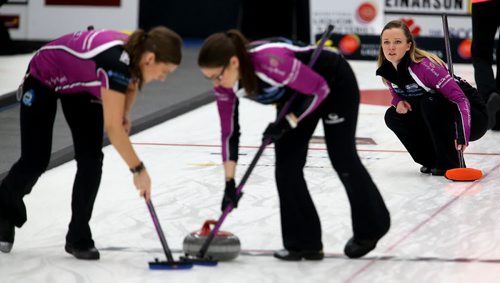 Kristen Foster and Lindsay Titheridge sweep for skip, Chelsea Carey after she throws a rock against Kerri Einarson during the final of the Scotties Provincial Curling Championship at the Tundra Oil & Gas Place in Virden, Manitoba, Sunday, January 12, 2014. (TREVOR HAGAN/WINNIPEG FREE PRESS)