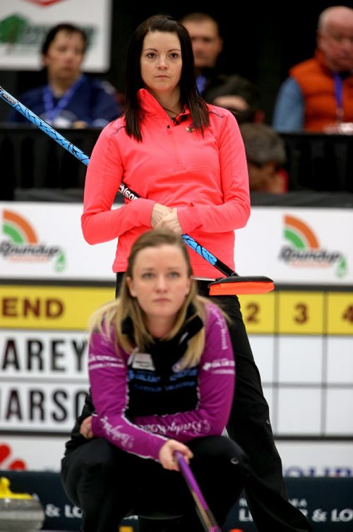 Kerri Einarson looks on as Chelsea Carey watches her sweepers early in the final of the Scotties Provincial Curling Championship at the Tundra Oil & Gas Place in Virden, Manitoba, Sunday, January 12, 2014. (TREVOR HAGAN/WINNIPEG FREE PRESS)