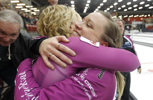 Chelsea Carey celebrates with Kristen Foster's mom, Karen Foster after defeating Kerri Einarson in the final of the Scotties Provincial Curling Championship at the Tundra Oil & Gas Place in Virden, Manitoba, Sunday, January 12, 2014. (TREVOR HAGAN/WINNIPEG FREE PRESS)