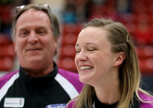 As her father and coach, Dan Carey looks on, Chelsea Carey smiles after defeating Kerri Einarson in the final of the Scotties Provincial Curling Championship at the Tundra Oil & Gas Place in Virden, Manitoba, Sunday, January 12, 2014. (TREVOR HAGAN/WINNIPEG FREE PRESS)