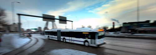 One of the city's new "Articulated" buses makes it's way across the Queen Elizabeth Way towards St Mary's Road Monday afternoon on an inagural run from downtown to South St Vital. See Alex Paul's story. January 13, 2014 - (Phil Hossack / Winnipeg Free Press)