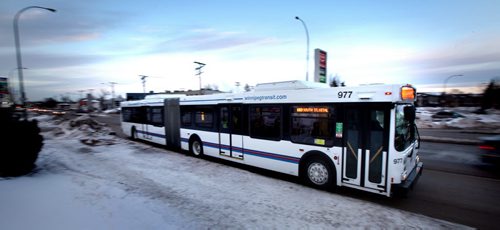 One of the city's new "Articulated" buses makes it's way down St Mary's Road Monday afternoon on an inagural run from downtown to South St Vital. See Alex Paul's story. January 13, 2014 - (Phil Hossack / Winnipeg Free Press)