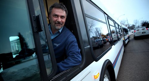 Eric Genereux guided one of the city's new "Articulated" buses out St Mary's Road Monday afternoon on an inagural run from downtown to South St Vital. See Alex Paul's story. January 13, 2014 - (Phil Hossack / Winnipeg Free Press)