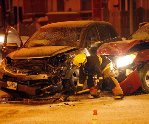 Stdup MVC , WFS firefighter clenas up debris from a two car MVC on Sherbrook St and on Cumberland Ave injured  two people to hospital , traffic is getting around the incident ,.JAN. 14 2014 / KEN GIGLIOTTI / WINNIPEG FREE PRESS