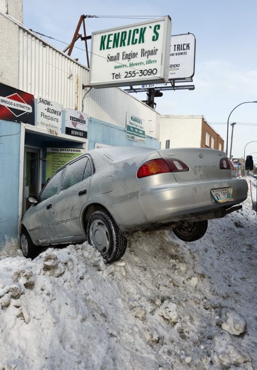 Single Vehicle MVC  car into a building  , car on snow bank hits Kenrick's Small Engine Repair at 984 St. Mary's Road , no injuries - JAN. 14 2014 / KEN GIGLIOTTI / WINNIPEG FREE PRESS