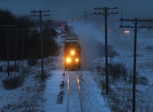 Blustery Day- A CN train travels East under the Perimeter Hyw bridge Wednesday morning  Warmer weather coming with 5CM of snow to Winnipeg with blustery conditions  Standup photo- Jan 15 , 2014   (JOE BRYKSA / WINNIPEG FREE PRESS). weather
