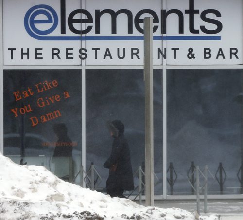 Stdup Äì Walking past  Elements Restaurant on Portage Ave  Weather -Winnipeg is  feeling the - 17 with high winds and blowing snow  JAN. 15 2014 / KEN GIGLIOTTI / WINNIPEG FREE PRESS