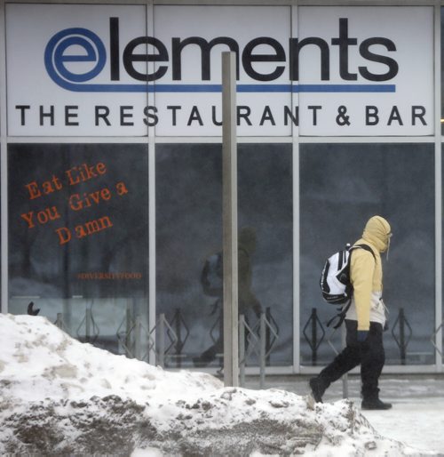 Stdup Äì Weather  - bundled and walking past Elements Restaurant on Portage Ave -Winnipeg is  feeling the - 17 with high winds and blowing snow  JAN. 15 2014 / KEN GIGLIOTTI / WINNIPEG FREE PRESS