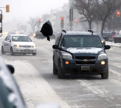 Stdup - This is garbage , a garbage bag swirls above traffic in high winds on Portage  Ave -Stdup Äì Weather -Winnipeg is  feeling the - 17 with high winds and blowing snow  JAN. 15 2014 / KEN GIGLIOTTI / WINNIPEG FREE PRESS