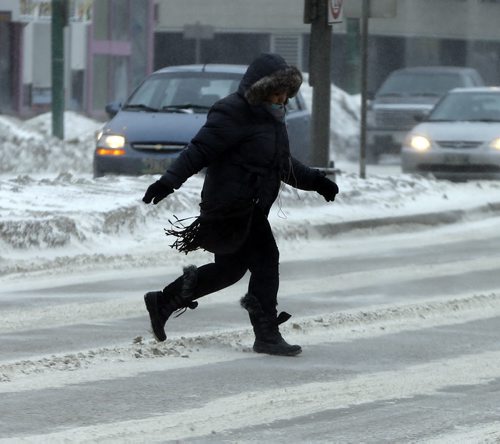 Stdup Äì Weather  pedestrian scoot across Portage Ave in cols blowing wind -Winnipeg is  feeling the - 17 with high winds and blowing snow  JAN. 15 2014 / KEN GIGLIOTTI / WINNIPEG FREE PRESS
