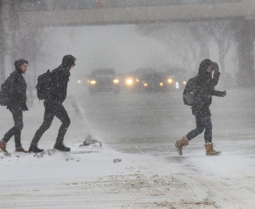 Pedestrians scramble across Portage Ave at Memorial in downtown Winnipeg through blustery weather conditions Wednesday near noon standup photo- Jan 15 , 2014   (JOE BRYKSA / WINNIPEG FREE PRESS)