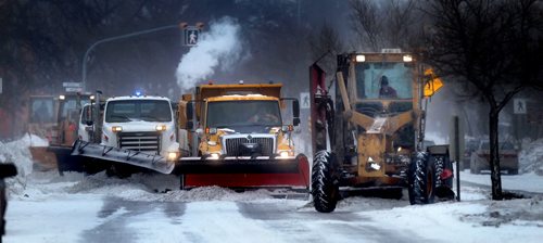 A line of snow clearing gear straddles the south bound lanes of St Mary's Road Wednesday afternoon as snow blew into town on a low pressure system, warming temperatures and reducing visibilty. See story. January 15, 2014 - (Phil Hossack / Winnipeg Free Press)