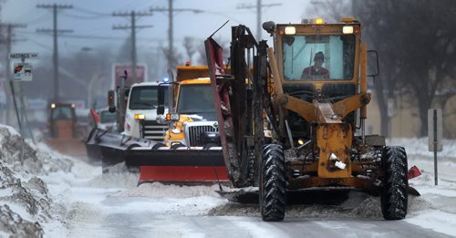 A line of snow clearing gear straddles the south bound lanes of St Mary's Road Wednesday afternoon as snow blew into town on a low pressure system, warming temperatures and reducing visibilty. See story. January 15, 2014 - (Phil Hossack / Winnipeg Free Press)