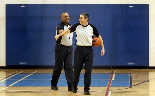 Good Call--Basketball referee's Wayne Banfield and Stewart McKenzie (right) give each other a pat on the back after officiating between the Carman Cougars and Gretna Blues Tuesday. They travel rural manitoba regularly in all types of weather to officiate matches in high school gyms.  See Nick Martin story. January 14, 2014 - (Phil Hossack / Winnipeg Free Press)