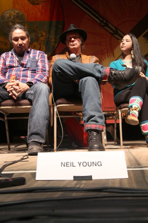 Neil Young held a news conference Thursday afternoon at the Centennial Concert hall where he discussed his Honour The Treaties tour that will play in Winnipeg tonight. The four-date tour that kicked off last Sunday in Toronto features Diana Krall. The short tour is raising money and awareness for the Athabasca Chipewyan First Nation Legal Defense Fund to help fight for their treaty rights in the development of the oil sands in Northern Alberta.  Neil Young , centre, next to Chief Allan Adam left See story- Jan 16, 2014   (JOE BRYKSA / WINNIPEG FREE PRESS)